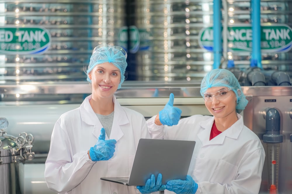 female-worker-inspecting-water-bottle-on-productio-2023-11-27-05-26-08-utc